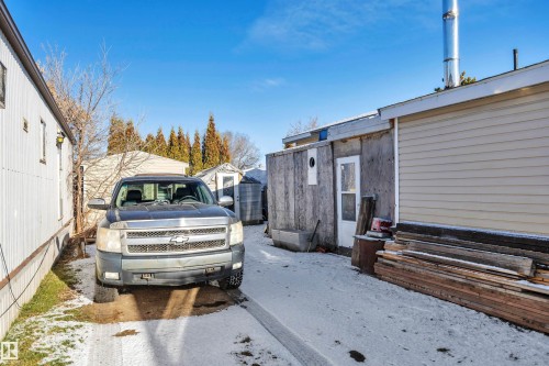 View of side of property featuring an outdoor structure - 21 Calmar Mobile Home Park, Calmar, AB - Outdoor