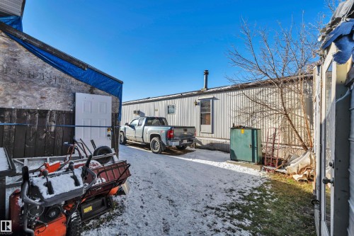View of snow covered parking - 21 Calmar Mobile Home Park, Calmar, AB - Outdoor With Exterior