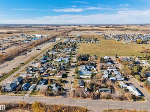 Aerial view of property and surrounding area with nearby suburban area - 21 Calmar Mobile Home Park, Calmar, AB - Outdoor With View