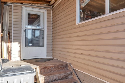 Doorway to property featuring a wooden deck - 21 Calmar Mobile Home Park, Calmar, AB - Outdoor With Exterior