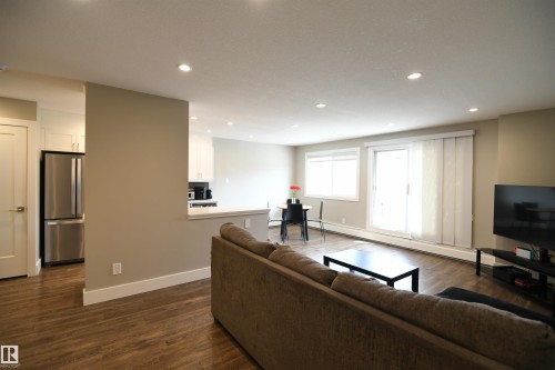 The south wall of glass brings in great natural light, and the patio doors lead to a generously sized private balcony.  A complete window covering package has also been installed, giving you control and options - 206 8125 110 Street, Edmonton, AB - Indoor Photo Showing Living Room
