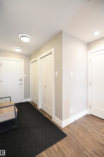 Many condos lack a proper entrance and storage.  Not this unit.  A formal entryway with double closet, and storage, keep your living and entertaining space inviting and organized - 206 8125 110 Street, Edmonton, AB - Indoor Photo Showing Other Room