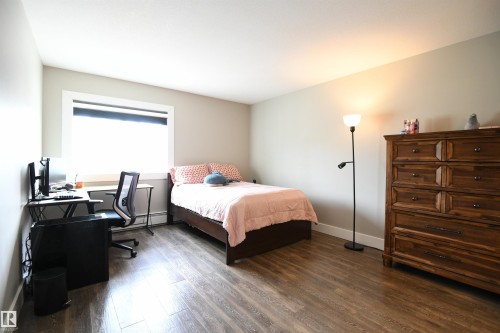 The master suite will easily support king sized furniture, and has a double walk through closet, as well as a spa quality 4 piece ensuite with tile, and contemporary finishes.  This bedroom is a welcome treat - 206 8125 110 Street, Edmonton, AB - Indoor Photo Showing Bedroom