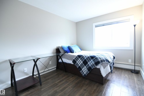 The second bedroom is also nicely sized, with extra room for a desk.  This setup is perfect for an active lifestyle or university life.  Nice closet size in this room as well - 206 8125 110 Street, Edmonton, AB - Indoor Photo Showing Bedroom
