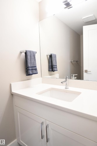 The hallway holds both a large storage room, and a very nice 2 piece bathroom - 206 8125 110 Street, Edmonton, AB - Indoor Photo Showing Bathroom