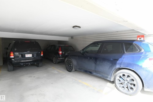 This unit has TWO COVERED parking stalls, a rare and welcome bonus in the area.  Having the ability to park two cars this close to the UofA and Whyte Avenue is a treat - 206 8125 110 Street, Edmonton, AB - Indoor Photo Showing Garage