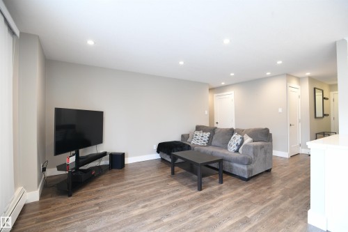 Great open layout and design with a wall removed between the kitchen and living room.  This is gorgeous living space - 206 8125 110 Street, Edmonton, AB - Indoor Photo Showing Living Room