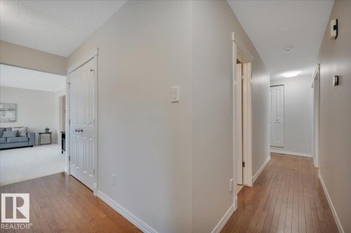 featuring hardwood floors - 705 Riddell Street, Edmonton, AB - Indoor Photo Showing Other Room
