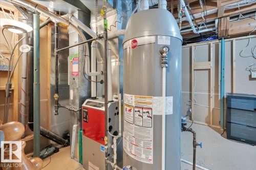With high efficiency furnace and 50 gallon hot water tank - 705 Riddell Street, Edmonton, AB - Indoor Photo Showing Basement