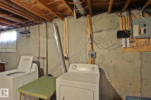 Dedicated laundry area featuring a top-load washing machine and a front-load dryer - 3539 104 Street, Edmonton, AB - Indoor Photo Showing Laundry Room