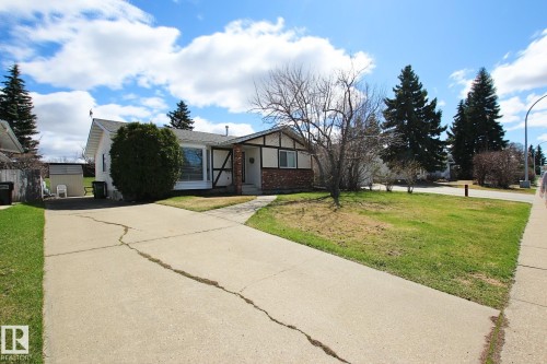 Ranch-style residence featuring a prominent bay window, white siding, and decorative half-timbering - 3539 104 Street, Edmonton, AB - Outdoor