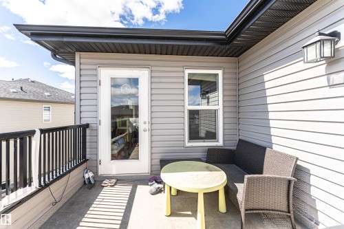 Outdoor balcony featuring gray siding and a black railing - 4452 Annett Common, Edmonton, AB 