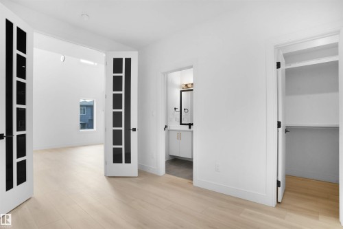 Bright interior space featuring light wood-finish flooring and white walls - 22139 81 Avenue, Edmonton, AB - Indoor Photo Showing Other Room