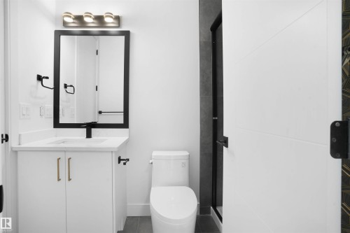 Bathroom vanity featuring a white countertop, under-mount sink, and matte black faucet - 22139 81 Avenue, Edmonton, AB - Indoor Photo Showing Bathroom
