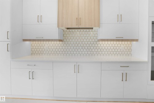 White shaker-style cabinetry with gold hardware, complement a hexagon tile backsplash - 22139 81 Avenue, Edmonton, AB - Indoor