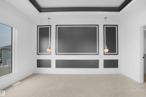 Accent wall with decorative molding and two pendant lights - 22139 81 Avenue, Edmonton, AB - Indoor Photo Showing Other Room