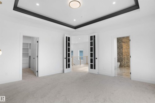 Spacious room featuring light-colored carpeting and a contrasting black tray ceiling with recessed lighting - 22139 81 Avenue, Edmonton, AB - Indoor Photo Showing Other Room