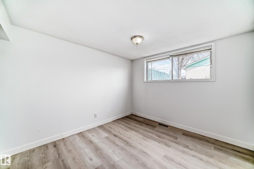 Room featuring light wood-finish flooring, white walls, and a single window - 12825 102 Street, Edmonton, AB - Indoor Photo Showing Other Room