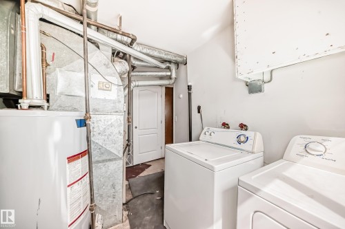 Dedicated utility area featuring a water heater, furnace, and exposed ductwork - 12825 102 Street, Edmonton, AB - Indoor Photo Showing Laundry Room