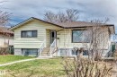 Single-story residence featuring light-colored siding, a brown roof, and a front entry staircase with white railings - 12825 102 Street, Edmonton, AB  - Outdoor 