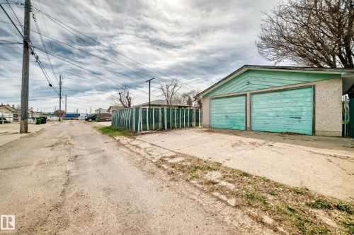Detached two-car garage with teal-painted doors and siding - 12825 102 Street, Edmonton, AB - Outdoor