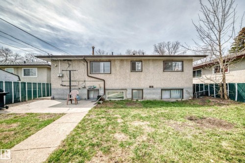 Rear exterior with stucco siding and multiple windows - 12825 102 Street, Edmonton, AB - Outdoor