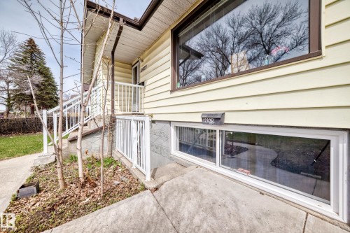 Exterior facade featuring light yellow horizontal siding - 12825 102 Street, Edmonton, AB - Outdoor With Exterior
