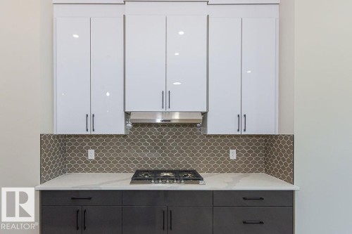 Modern kitchen with white upper cabinetry and dark lower cabinetry - 9814 155 Street, Edmonton, AB - Indoor Photo Showing Other Room