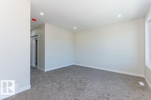Carpeted room with recessed lighting and a window - 9814 155 Street, Edmonton, AB - Indoor Photo Showing Other Room