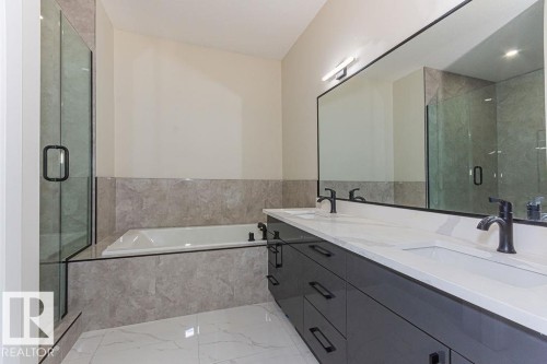Modern bathroom featuring a dual vanity with white countertops and matte black fixtures, a built-in tub, a glass-enclosed shower, and large format floor tiling - 9814 155 Street, Edmonton, AB - Indoor Photo Showing Bathroom