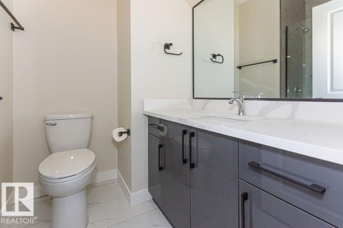 Modern vanity featuring grey cabinetry, a white countertop, and a rectangular undermount sink - 9814 155 Street, Edmonton, AB - Indoor Photo Showing Bathroom