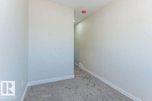 Light gray painted walls with white baseboards and gray carpet flooring - 9814 155 Street, Edmonton, AB - Indoor Photo Showing Other Room