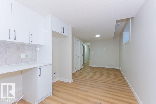 Open-concept room featuring wood-finish flooring, recessed lighting, and a window - 9814 155 Street, Edmonton, AB - Indoor
