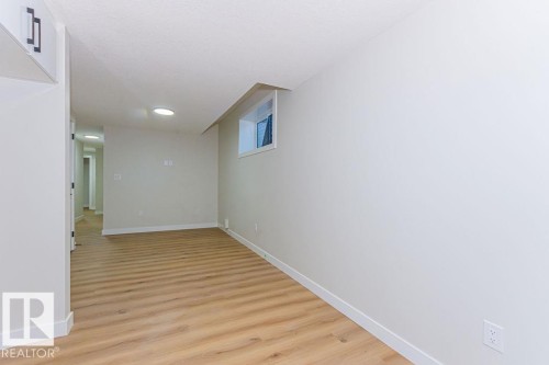 Bright interior space featuring wood-finish flooring, recessed lighting, and a neutral color palette - 9814 155 Street, Edmonton, AB - Indoor Photo Showing Other Room
