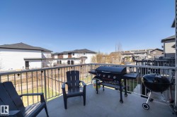 Outdoor balcony featuring a textured concrete surface and sturdy metal railings - 
