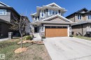Contemporary two-story residence featuring a two-car garage with a wood-finish door - 2016 Redtail Common, Edmonton, AB  - Outdoor With Facade 