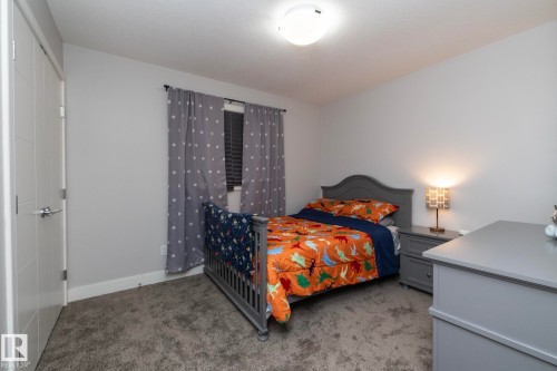 Bedroom featuring light gray walls, gray carpeting, and a window with blinds - 2016 Redtail Common, Edmonton, AB - Indoor Photo Showing Bedroom