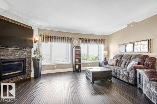 602 8728 Gateway Boulevard, Edmonton, AB - Indoor Photo Showing Living Room With Fireplace