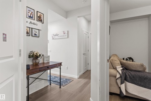 Hallway featuring wood-finish flooring, white walls, and white trim - 1471 Plum Circle Circle, Edmonton, AB - Indoor Photo Showing Other Room