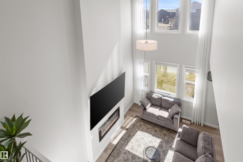Two-story living area featuring a vaulted ceiling and an abundance of natural light - 1471 Plum Circle Circle, Edmonton, AB - Indoor