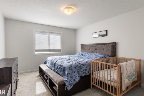 Bedroom featuring light gray walls, white trim, and light-colored carpet flooring - 1471 Plum Circle Circle, Edmonton, AB - Indoor Photo Showing Bedroom