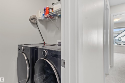 Dedicated laundry area featuring a wire shelf and light gray walls - 1471 Plum Circle Circle, Edmonton, AB - Indoor Photo Showing Laundry Room