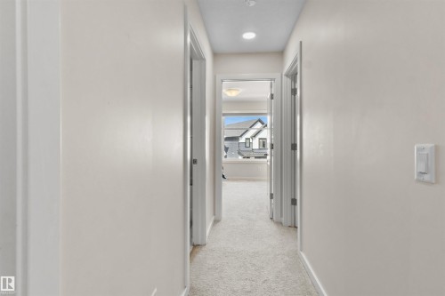 Hallway featuring light-toned carpeting and neutral wall finishes - 1471 Plum Circle Circle, Edmonton, AB - Indoor Photo Showing Other Room