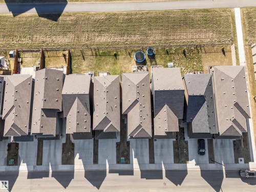 Aerial perspective showcasing multiple properties featuring asphalt shingle roofing and individual concrete driveways - 1471 Plum Circle Circle, Edmonton, AB - Outdoor
