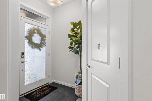 Entryway featuring a full-light door with transom window, white trim, and a flush-mount ceiling light fixture - 1471 Plum Circle Circle, Edmonton, AB - Indoor Photo Showing Other Room