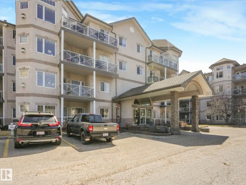 Multi-story residential building featuring a stone-clad entrance canopy with columns - 317 2420 108 Street, Edmonton, AB - Outdoor With Balcony With Facade