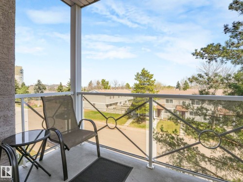 Private balcony with concrete flooring, white railing, and glass inserts - 317 2420 108 Street, Edmonton, AB - Outdoor With Balcony With Exterior