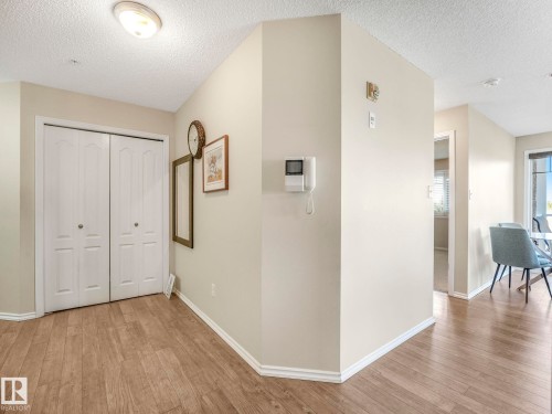 Entryway featuring wood-finish flooring, white baseboards, and a flush-mount ceiling light - 317 2420 108 Street, Edmonton, AB - Indoor Photo Showing Other Room