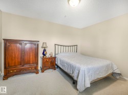 Neutral-toned walls complement the textured ceiling and carpeted flooring - 