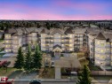 Multi-story residential building with light-toned exterior and dark gabled roofs, featuring multiple private balconies with decorative railings - 317 2420 108 Street, Edmonton, AB  - Outdoor 